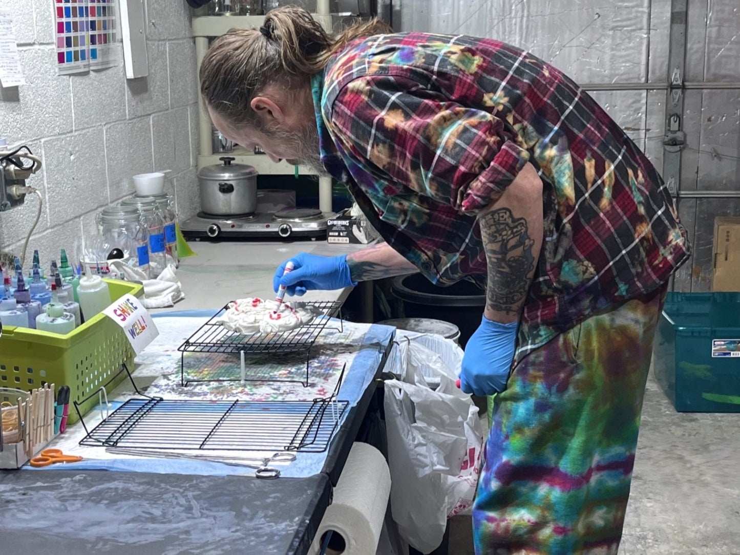 Russ, The Tie Dye Guy, marking a shirt prior to dyeing it in our Dye Lab