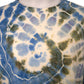 Close up spiral tie dye pattern blue green purple hand dyed cotton top detail