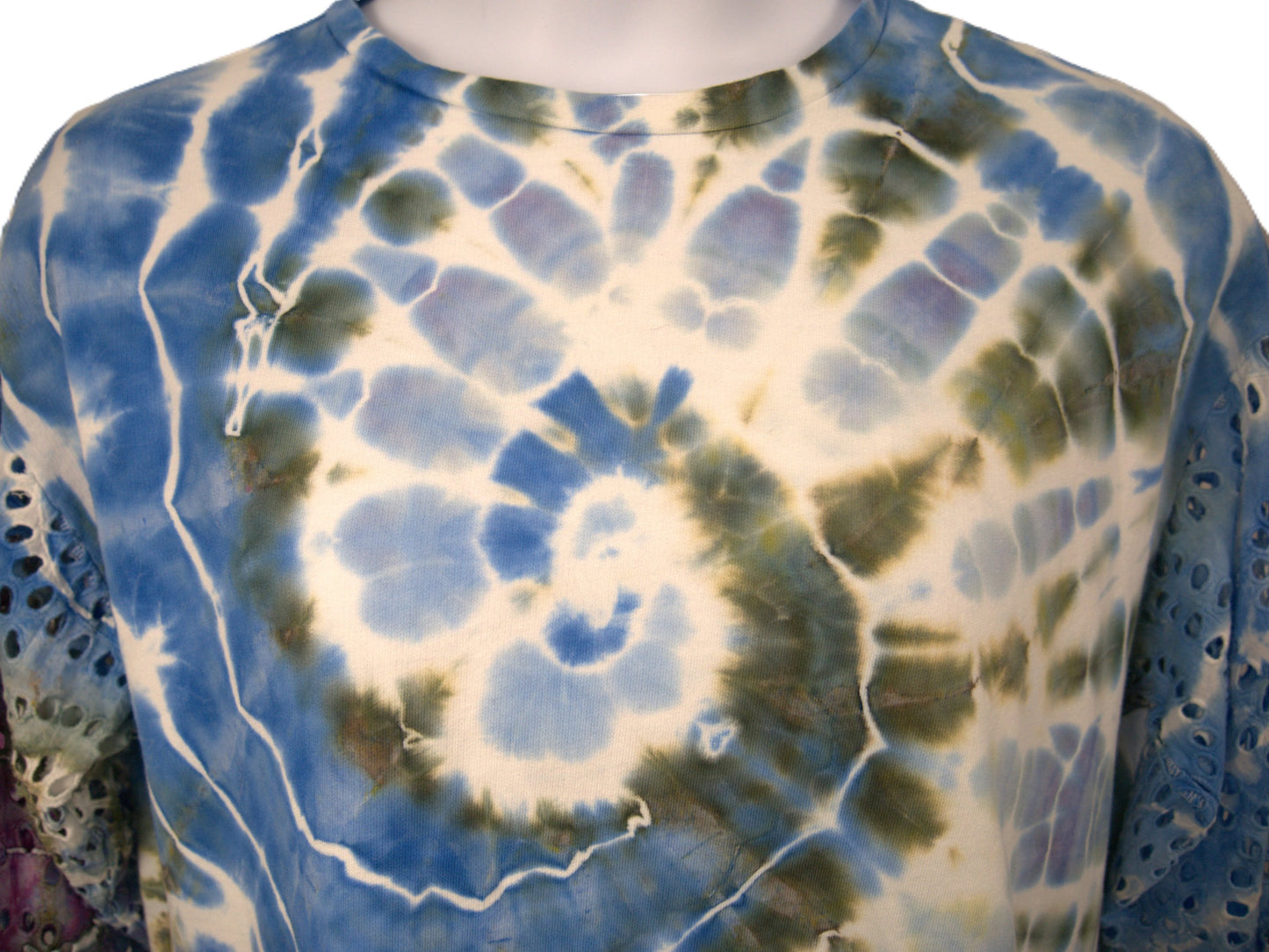 Close up spiral tie dye pattern blue green purple hand dyed cotton top detail