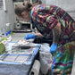 Russ, The Tie Dye Guy, marking a shirt prior to dyeing it in our Dye Lab