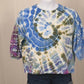 360 degree rotating view of hand dyed tie dye top size XXL showing blue green purple spiral pattern and eyelet lace sleeve detail